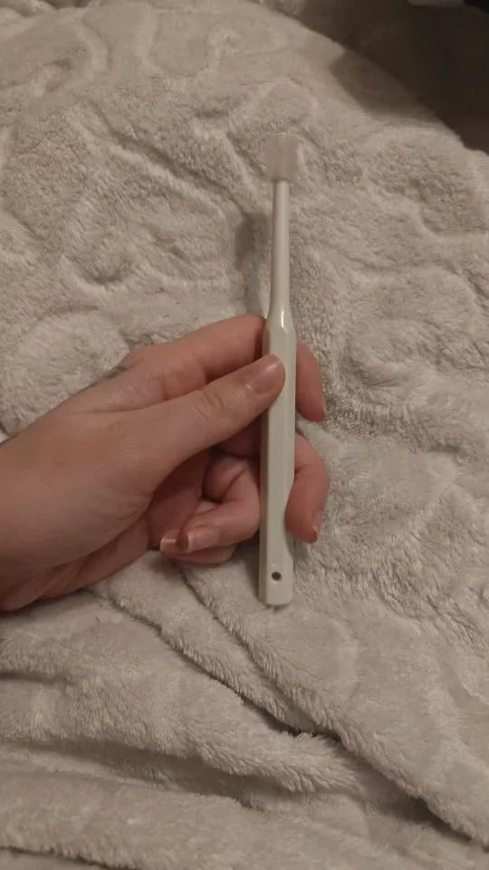 Customer holding the 360 ToothBrush in her hands
