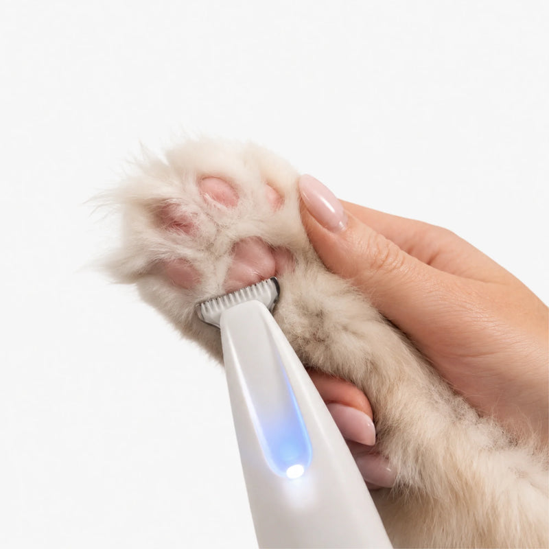 RagRoyale FurTrim gently trimming fur between a cat's paw pads for safe and even grooming