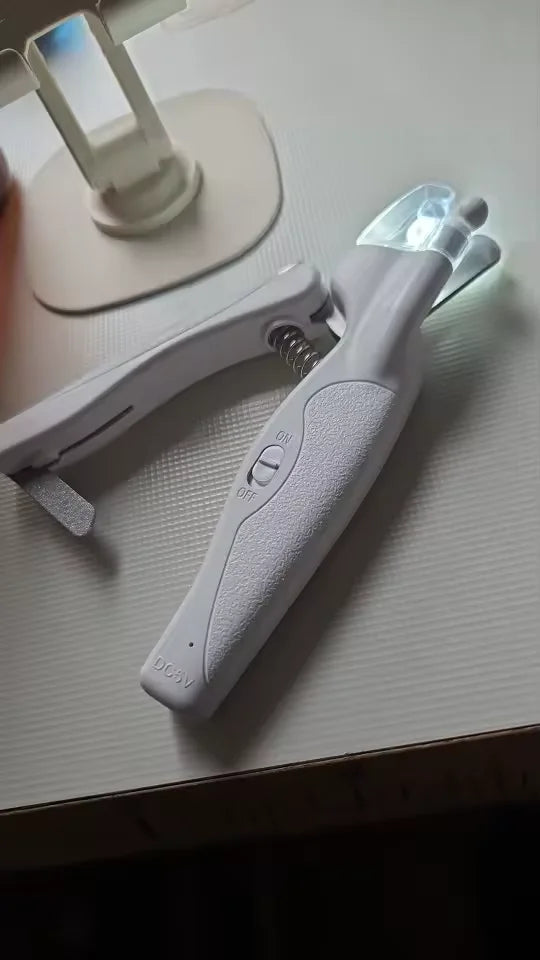 Customer showing LED nail clipper before cat nail trimming