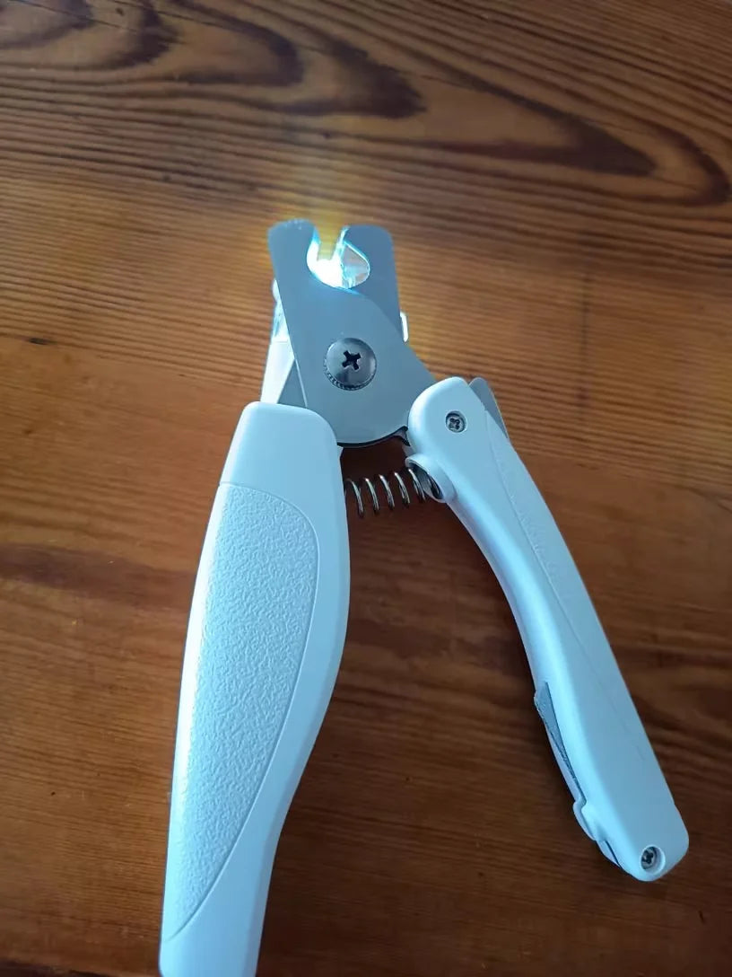 Customer showing RagRoyale LED nail clipper before cat nail trimming