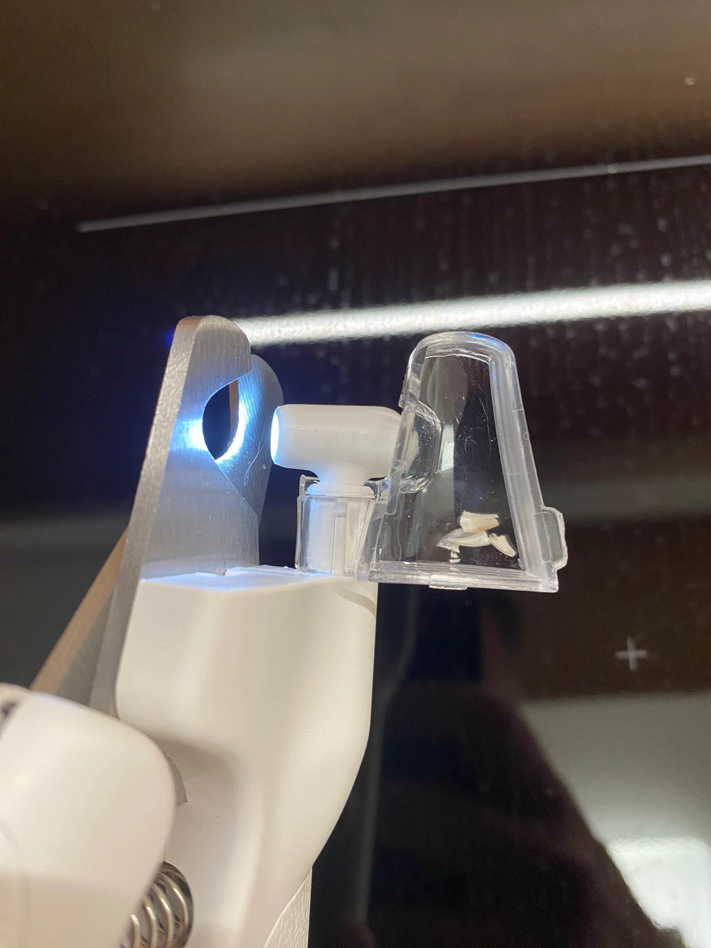 Customer showing the collected nail clippings of his cat in the LED clipper
