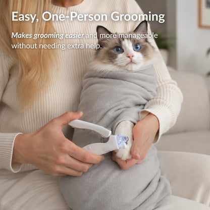 Woman using the RagRoyale GroomWrap to safely trim a cat's nails without assistance during grooming